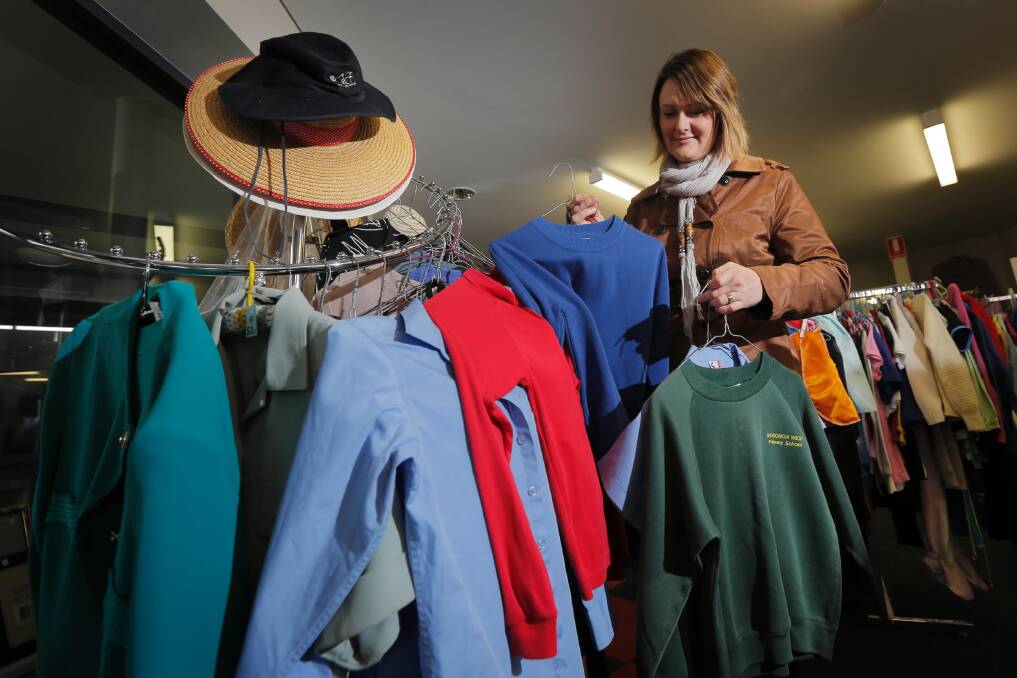 UnitingCare Wodonga will operate a temporary op-shop to sell secondhand primary school uniforms at a discounted price. Marketing and fund-raising co-ordinator Alison Reed sorts through some of the uniforms that will be available. Picture: TARA GOONAN