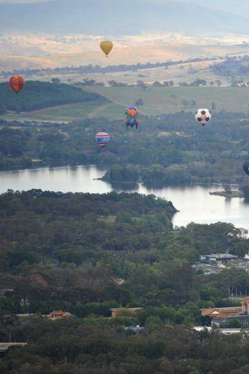  Balloons drift over Lake Burley Griffin. Photo: Graham Tidy