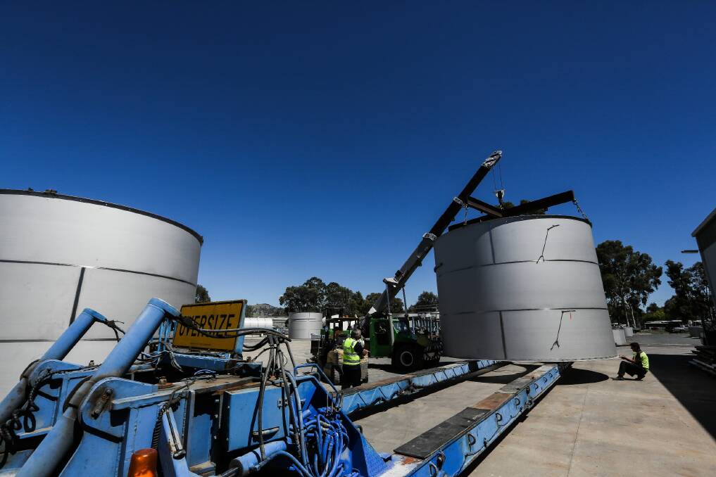 A crane lifts a section of one of the 450-tonne tanks onto a truck at Wodonga’s JC Butko Engineering. Picture: DYLAN ROBINSON