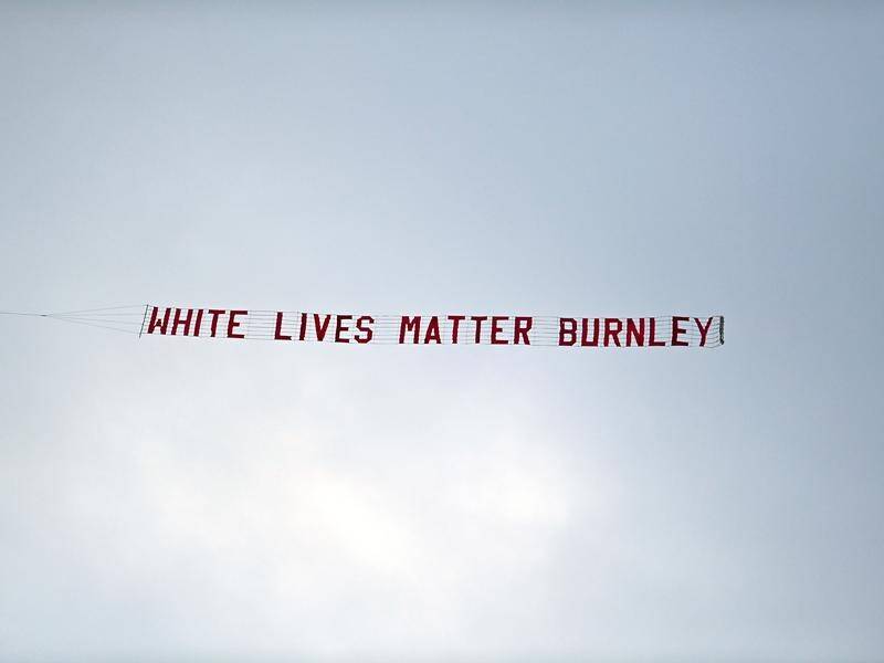 A 'White Lives Matter Burnley' banner is flown above the Eithad Stadium on Monday night.