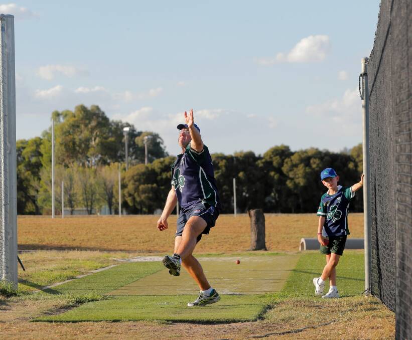 Dad, are you ever going to retire? St Patrick’s captain Heath Naughton sends one down at training while his son, Sam, looks on. Picture: TARA GOONAN