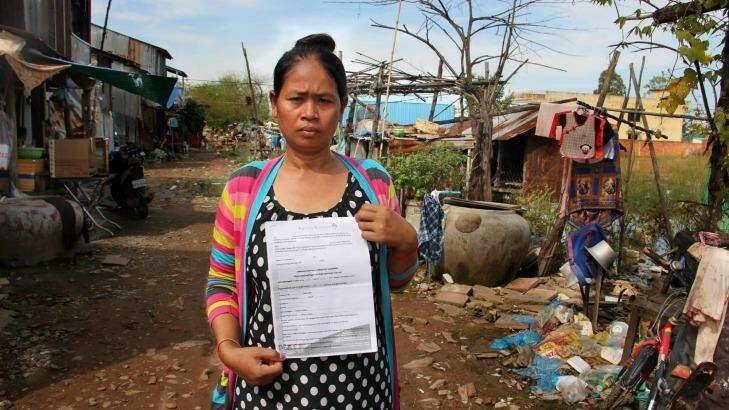 Cambodian surrogate mother Hour Vanny, holding the two-page document she signed with Fertility Solutions, operated by Australian nurse Tammy Davis-Charles.   Photo: Craig Skehan