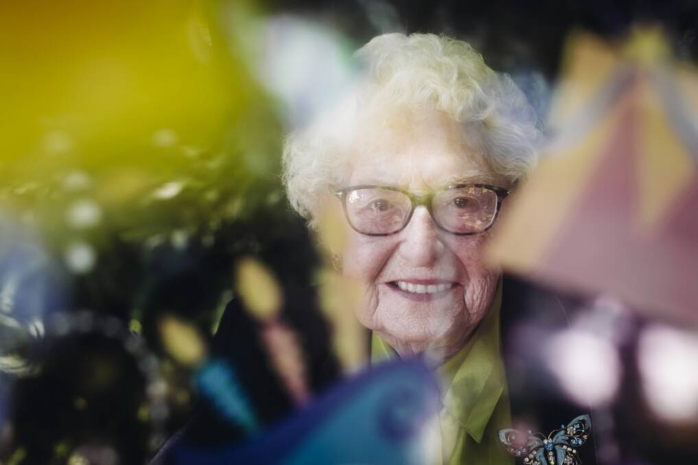 Ivy Martin looks through a balloon as she celebrates her 103rd birthday. Picture: DYLAN ROBINSON