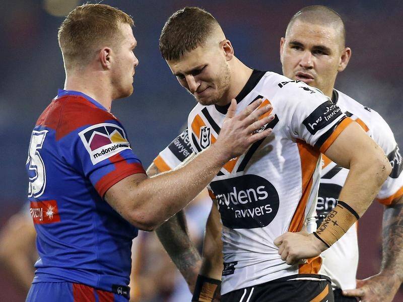 West Tigers' Adam Doueihi is consoled by Newcastle's Josh King after Saturday's NRL clash.