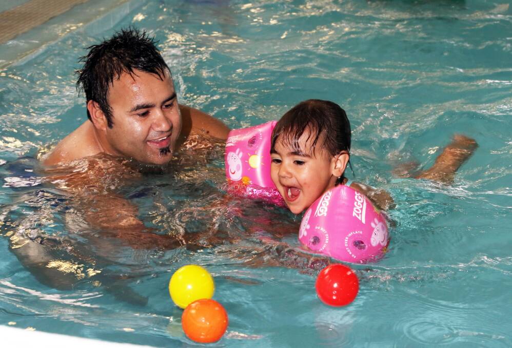 Derek Murray and his daughter Jaydah, 2, of Albury are part of the indigenous swim program. Picture: PETER MERKESTEYN