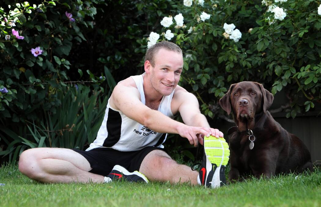 Daniel Searle, of Albury, is legally blind but will be competing in the Nail Can Hill run in May. He is pictured with his dog Bear. Picture: KYLIE ESLER