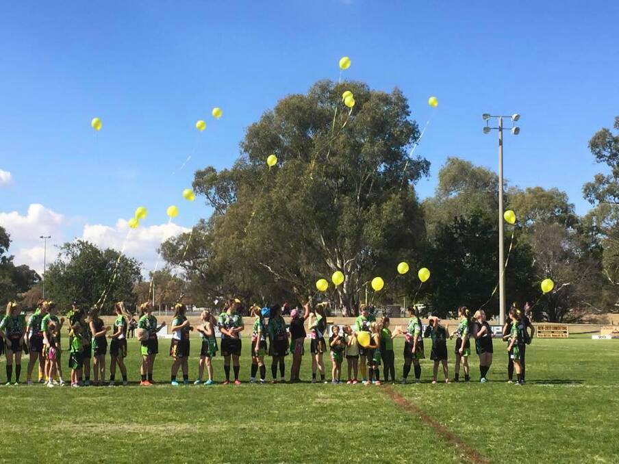 Albury Thunder players release balloons at Greenfield Park yesterday. Pictures: DEBBIE MOSBEY