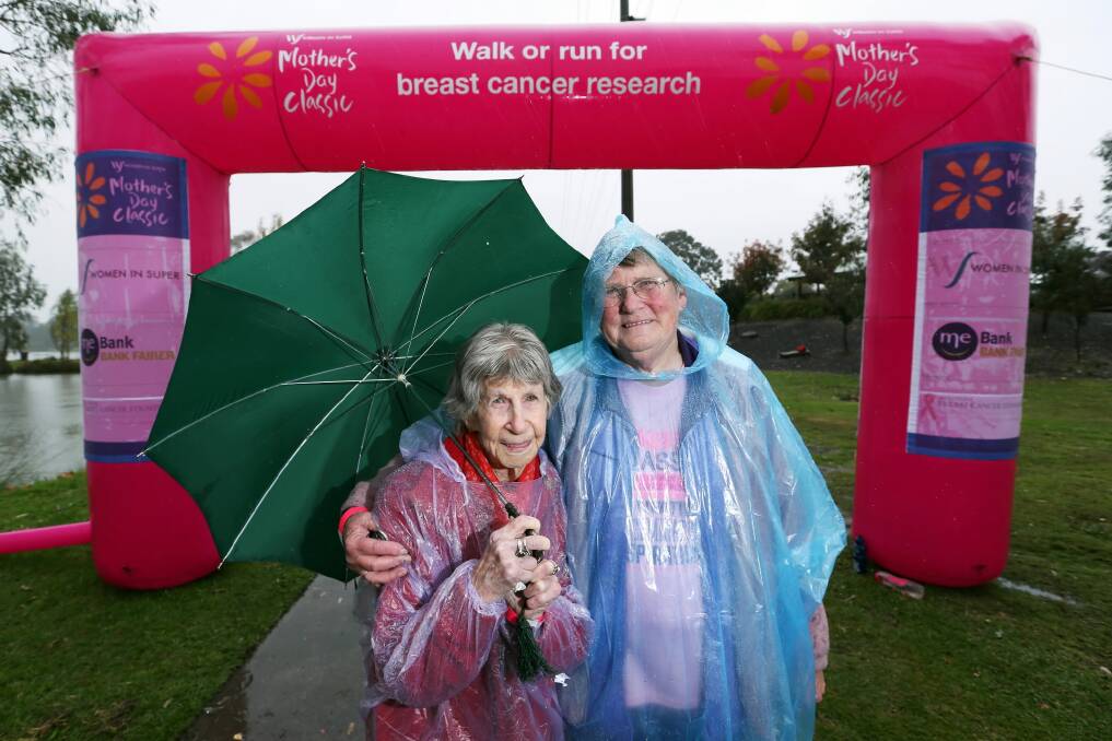 Hazel Fox, 100, and her daughter Lesley Baker, of Yackandandah, brave the wet weather to walk in the Mother’s Day Classic.