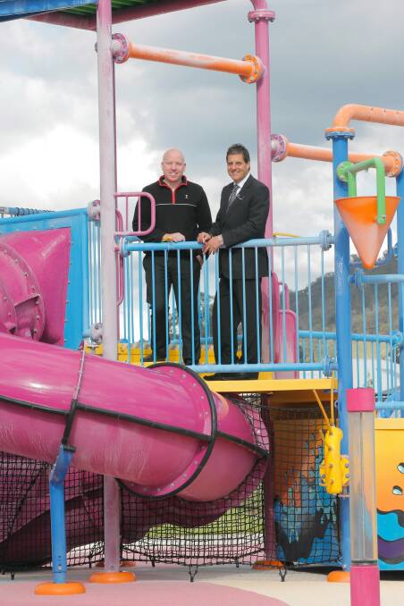 WAVES manager Andrew Mundy and Wodonga Council acting chief Trevor Ierino on the children’s splash pad, which was one of the aspects of the centre that clinched the award. Picture: TARA GOONAN