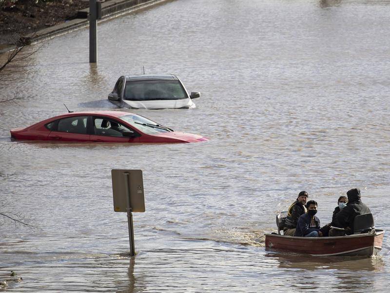 People stranded by flooding are rescued in the Canadian province of British Columbia.