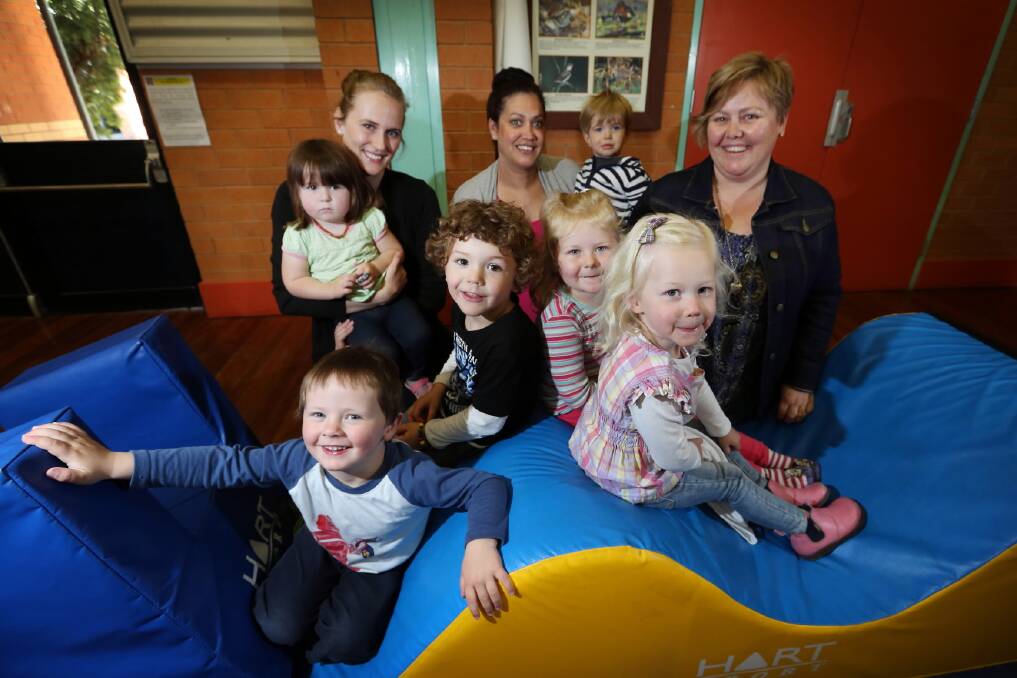 SPICE student Alana Turbitt, Playgroup NSW co-ordinator Chantel Jeffery, holding her son Cairden, 18 months, and CSU student Abi Meyer, who has post-grad diploma in inclusive education and is a learning support mentor with the program, with some of the children who attend the Jindera playgroup which has been operating recently. Picture: MATTHEW SMITHWICK