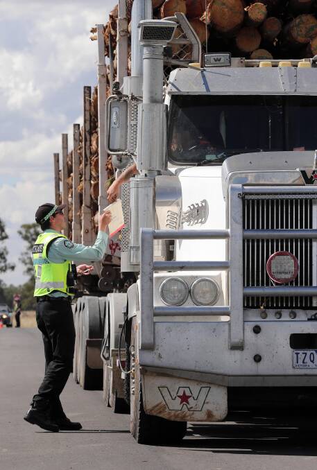 Victoria Police lend their weight to the sheriff’s operation on the Hume Freeway near Wangaratta this week. The operation caught up with more than $95,000 in unpaid fines. Picture: JOHN RUSSELL