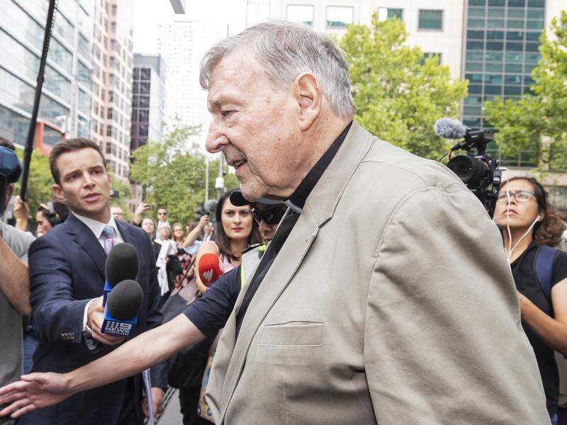 Cardinal George Pell has been heckled outside amid chaotic scenes.