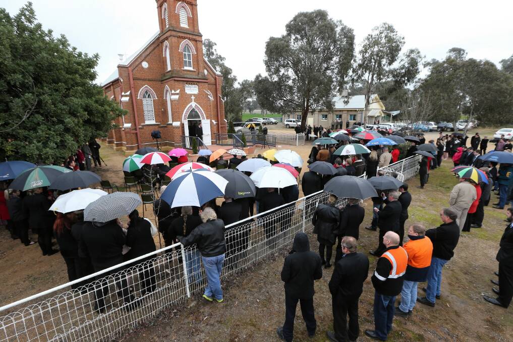 Special candles burned and mourners spilled into the grounds of the church. Pictures: JOHN RUSSELL