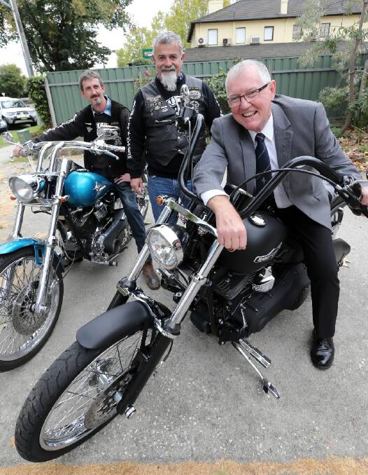 Party Unlimited’s vice-president Darren “Salty” Ellis and sergeant at arms Barry Parker put the final touches on their Anzac Day poker run with Albury Legacy Club president Steve Conte. Picture: PETER MERKESTEYN