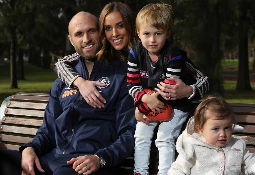 Chris and Rebecca Judd and their children, Oscar and Billie, enjoy a family moment near Ikon Park after the Carlton press conference in which Chris announced the end of his storied 279-match career yesterday. Picture: GETTY IMAGES