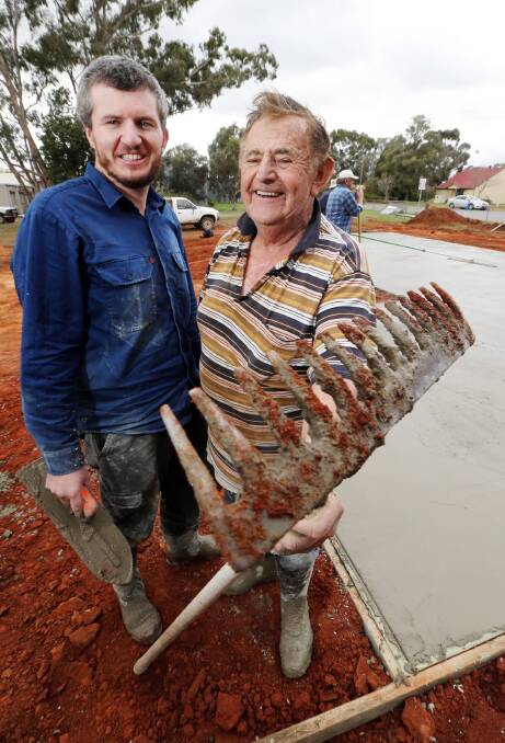 Adam and Ron Richardson lay the first slab for the Oaklands Men’s Shed. Picture: JOHN RUSSELL