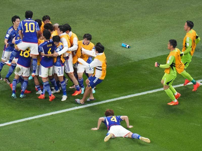Japan celebrate after Takuma Asano puts them 2-1 ahead in the World Cup victory over Germany. (AP PHOTO)