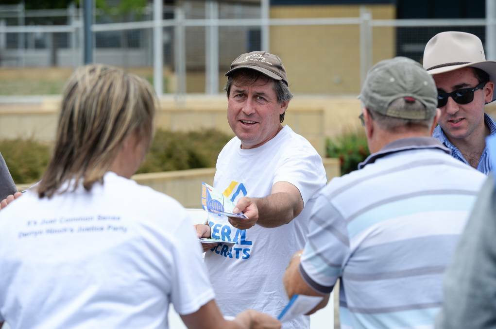 Tim Quilty handing out how to vote cards during the 2018 Victorian election. 