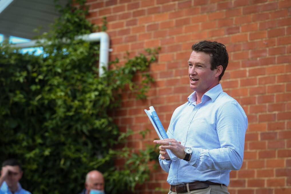 SOLD: Auctioneer Lachlan Hutchins of Stean Nicholls at the 613-615 Schubach Street, East Albury, auction on Saturday. Picture: JAMES WILTSHIRE 