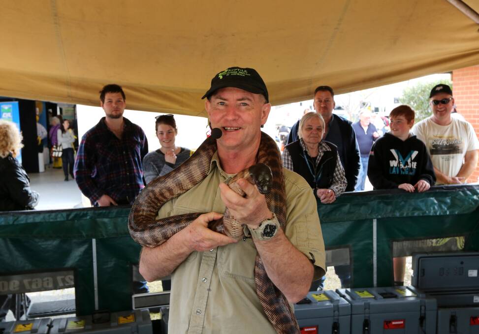 HISS: Allan Burnett from Reptile Awareness Display of Australia with a Black Headed Python. Mr Burnett will be hosting 20-minute shows from 9am to 4pm at the Henty Machinery Field Days which start on September 17. 