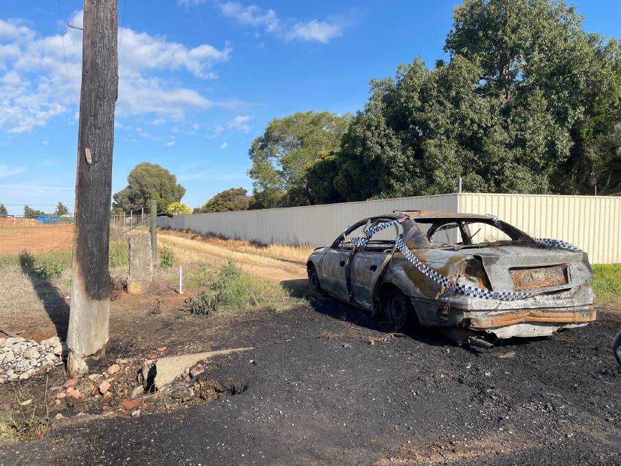 WELL ALIGHT: Fire scorched a power pole and completely destroyed a car off Third Avenue in Henty in the early hours of Saturday morning. 