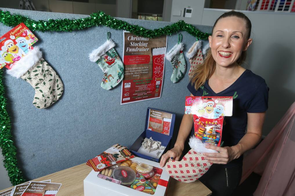 DOING IT FOR THE KIDS: Krystal Kaye is working to make and fill 400 stockings for children facing hardship to receive this Christmas. Miss Kaye is hosting a fundraiser this Saturday to help cover costs. Picture: TARA TREWHELLA 