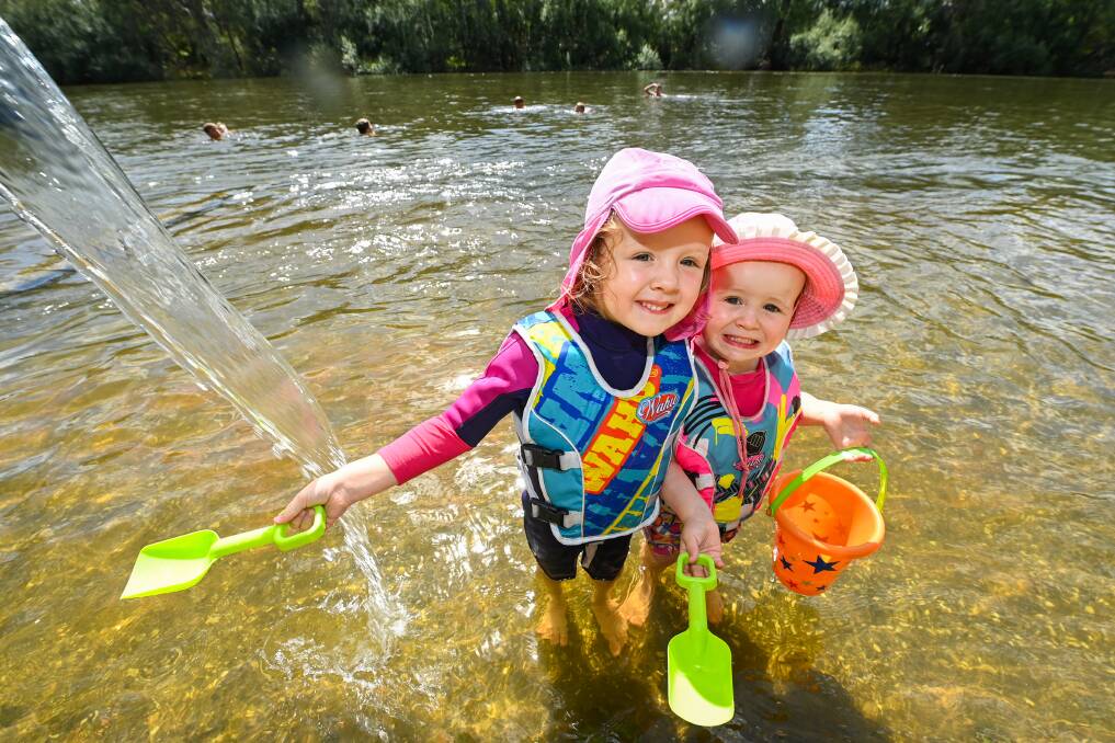 WATER FUN: Albury's Hayley Agar, 4, with her sister Alice, 2, cool off and play in the water at Noreuil Park making 'wombat stew'. Residents have been warned to stay cool and alert as a heatwave crosses the region. Picture: MARK JESSER