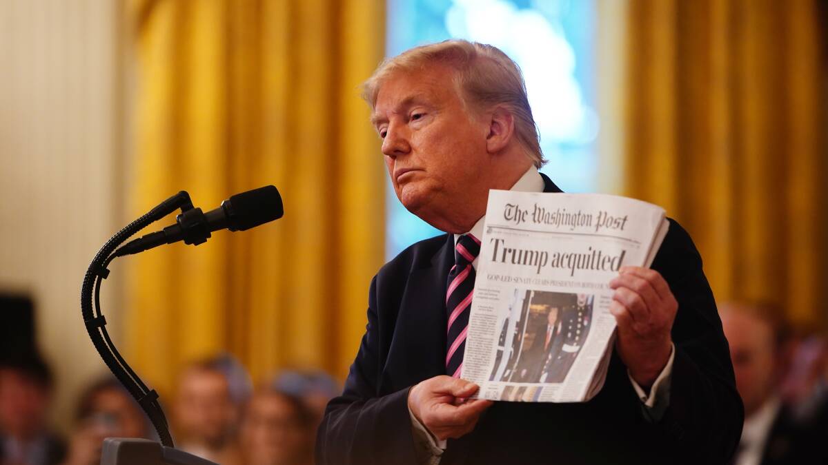 US President Donald J. Trump holds the front page of the Washington Post with headline 'Trump acquitted' as he speaks in the East Room of the White House a day after his Senate impeachment trial acquittal in Washington, DC, USA, 06 February 2020.