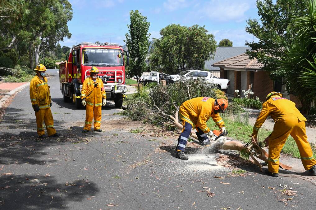 HARD WORK: The Baranduda Country Fire Authorities help with the clean up on Windsor Street.