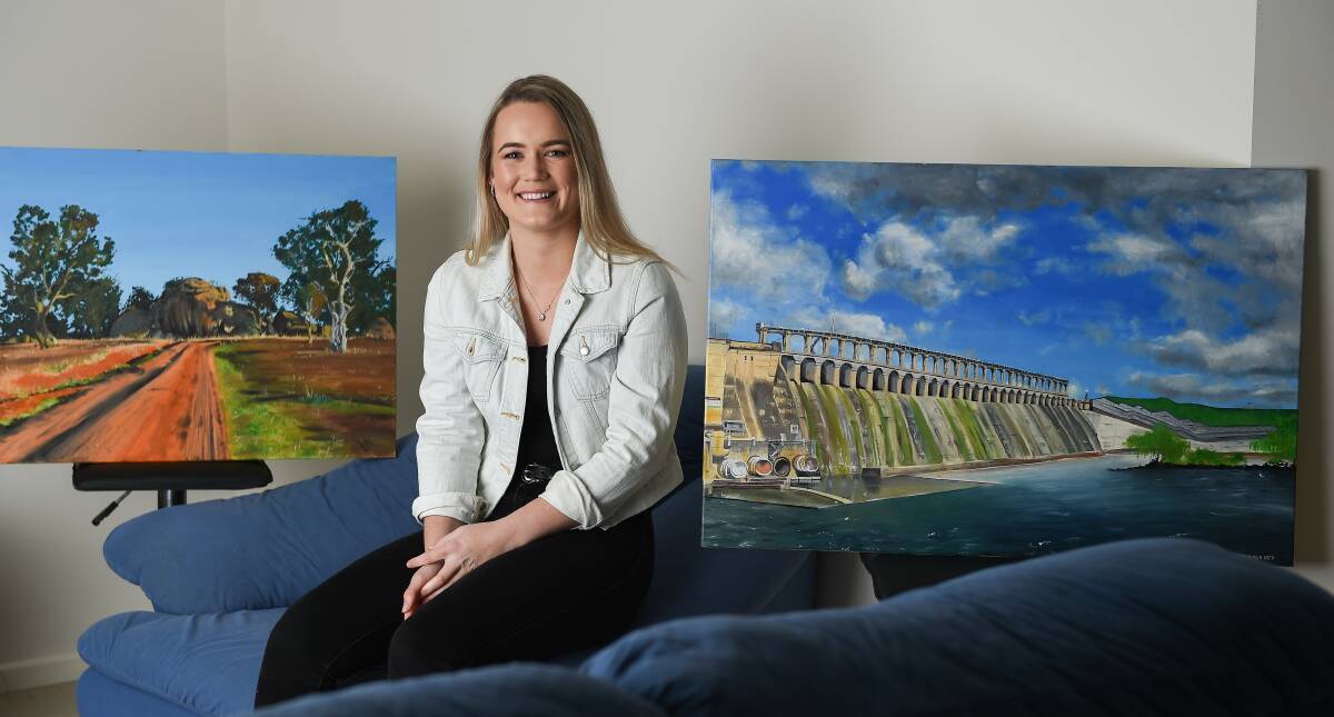 TALENT: Mikayla Heir with her first ever oil painting, Morgan's Lookout and second try at the medium, the Hume Weir. Picture: MARK JESSER