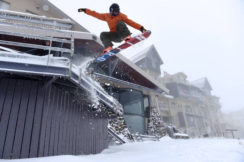 NEW HEIGHTS: Dan Aitchson, 28, takes to the air after the snowfalls at Hotham Alpine Resort. Picture: CHRIS HOCKING