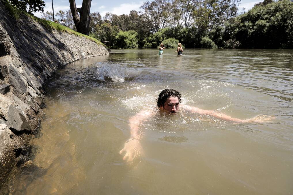 DIVING FOR RELIEF: Izac Hutchinson of Thurgoona, escapes the heat on Thursday, cooling off near Noreuil Park. Picture: JAMES WILTSHIRE