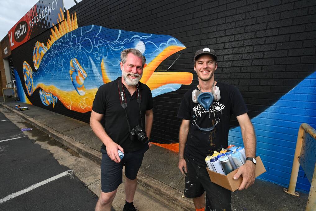 Coowner of Mahonys Newsagency, Kieran Mahony, with artist Lukas Kasper. 