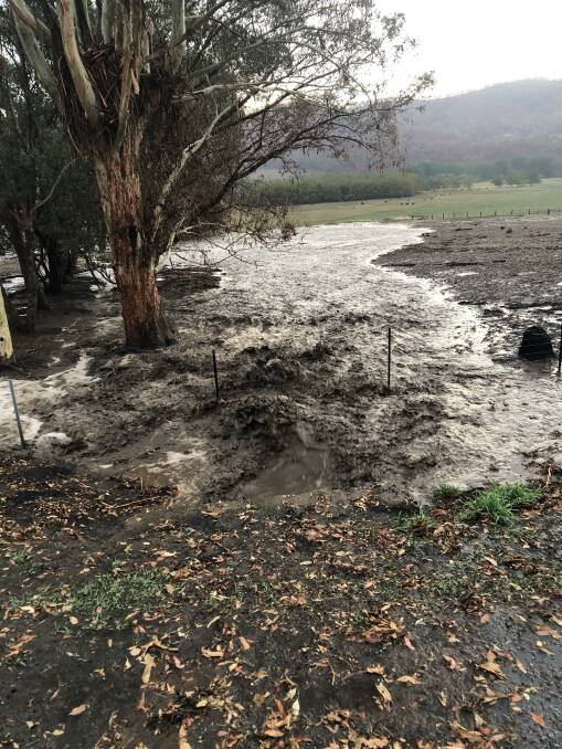 RAGING: Rain flows over paddocks during an intense 30-minute storm in Nariel Valley which resulted in destruction. 