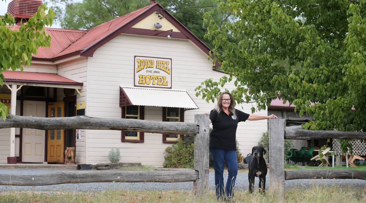 GROWING: Round Hill Hotel publican Jo Kollard and dog Diesel has seen plenty of change in their 10 years behind the bar, but for small town Morven the pub acts as a community hub, even hosting Valentine's Day match-making. Picture: KYLIE ESLER