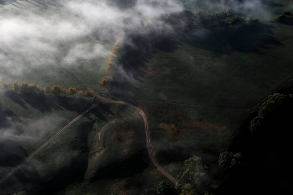 SKY HIGH: Fog settles across paddocks near Albury, as seen from a hot-air balloon during a flight in the early hours of Wednesday morning. Picture: JAMES WILTSHIRE