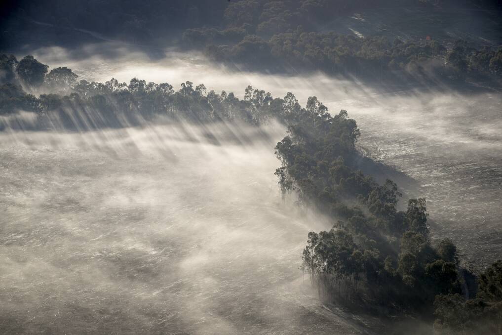 SKY HIGH: Fog settles across paddocks near Albury, as seen from a hot-air balloon during a flight in the early hours of Wednesday morning. Picture: JAMES WILTSHIRE