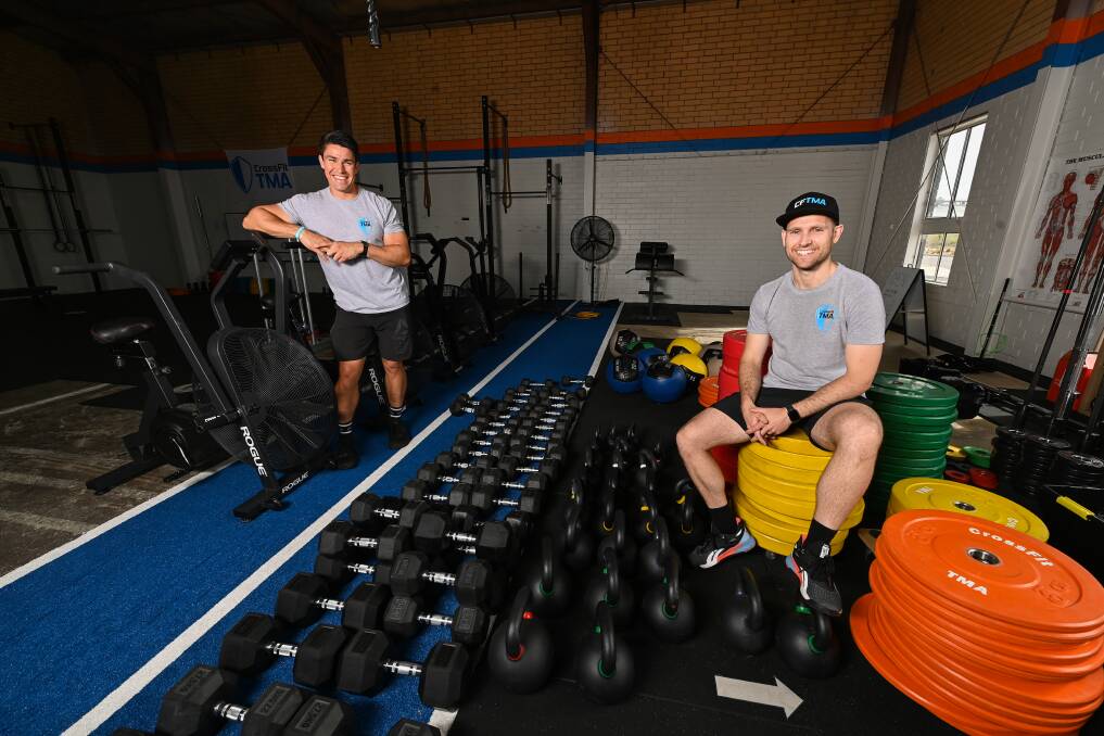 SWEATING CHANGE: CrossFit TMA's Zak Rogers and Scott Foley. The gym will be reopening classes with ten people from Wednesday. Picture: MARK JESSER