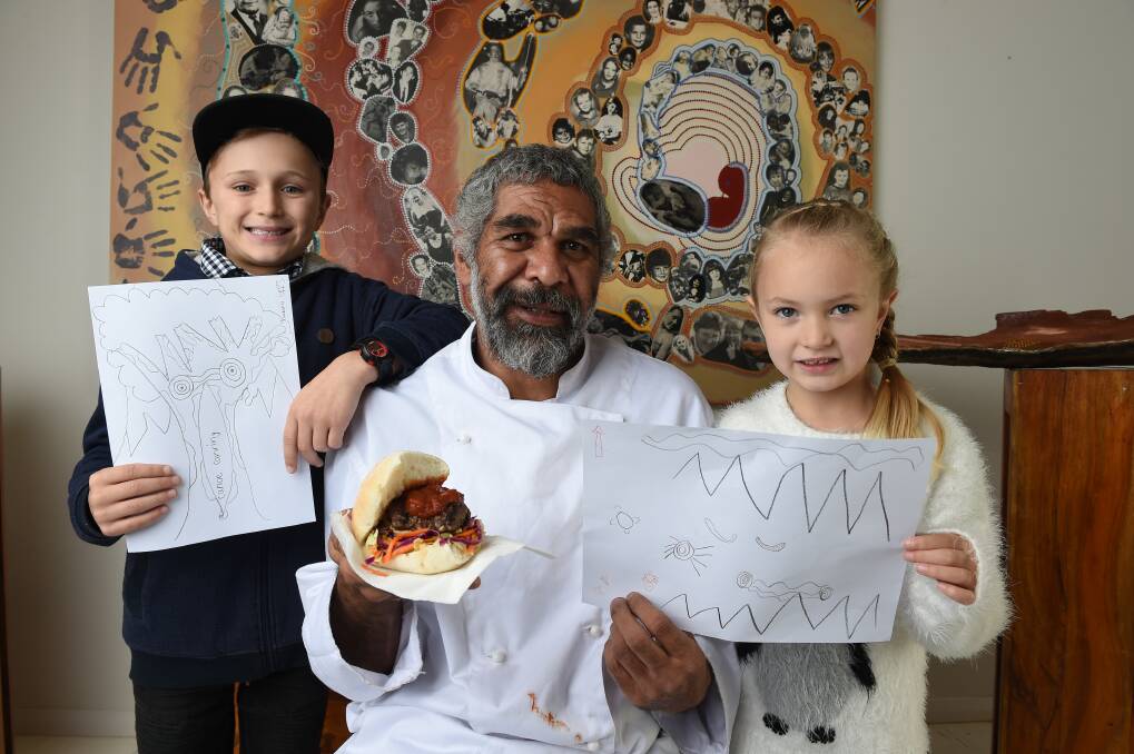 EMBRACE: Chef Sunny Morgan with a kangaroo slider he was making for the kids and Seth Morris, 9, and Imogen Morris, 6, of Thurgoona with some art made during the Kookaburra Kalling. Picture: MARK JESSER
