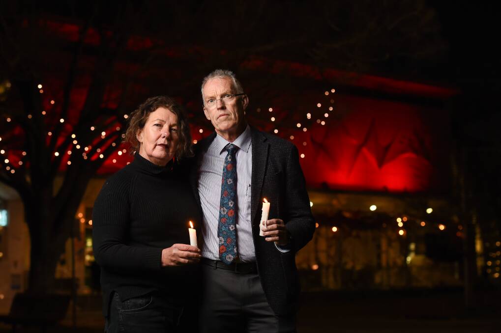 BRAVE: Annette and Stuart Baker. Albury's MAMA gallery was lit up red in honour of Winter Solstice as a tribute to sculptor Matthew Harding who created the facade and died by suicide in 2018. Picture: MARK JESSER
