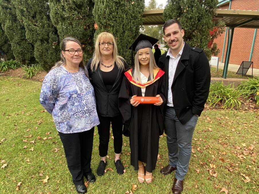 HAPPY: Ruth Russell, Susan Parks, Zoe Russell and her partner Brendan Celi. Miss Russell graduated with a Bachelor of Occupational Therapy in 2020.