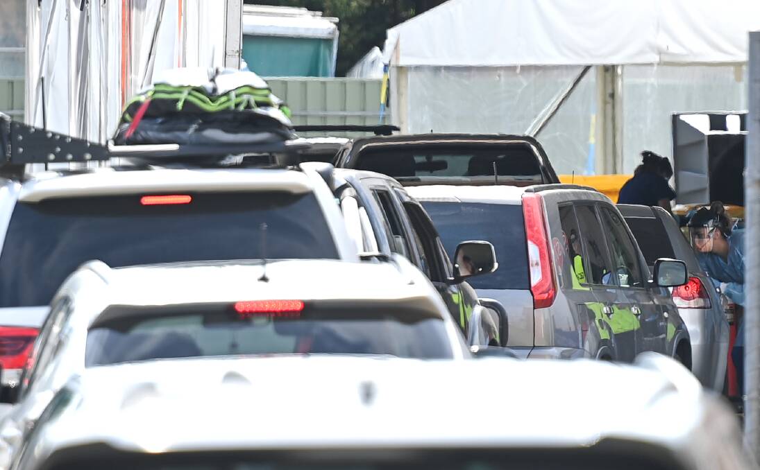 Cars line up for COVID tests. Many clinics saw a massive influx of visitors when Victoria closed their border and mandated testing for returnees. 