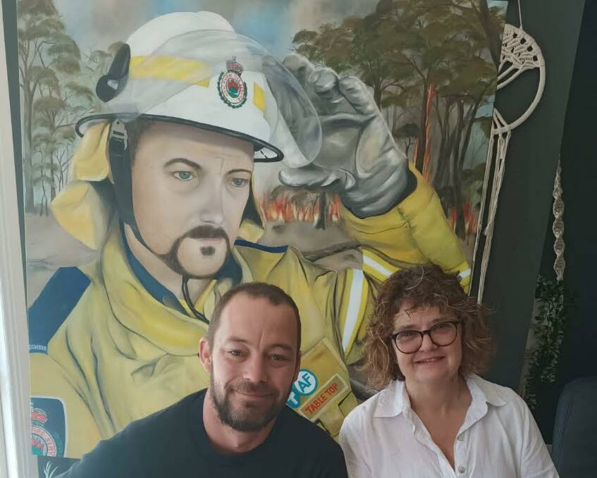 UNITED: Rural Fire Service volunteer Jason Davis with Granya artist Lisa Davis-Laidlaw with the completed work. The self-taught painter created a portrait of the firefighter to enter in the 2021 Archibald Prize.