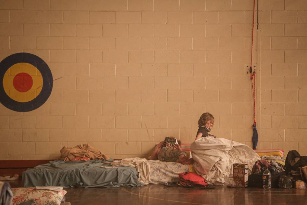 Family sleeping in the relief centre. Picture: JAMES WILTSHIRE