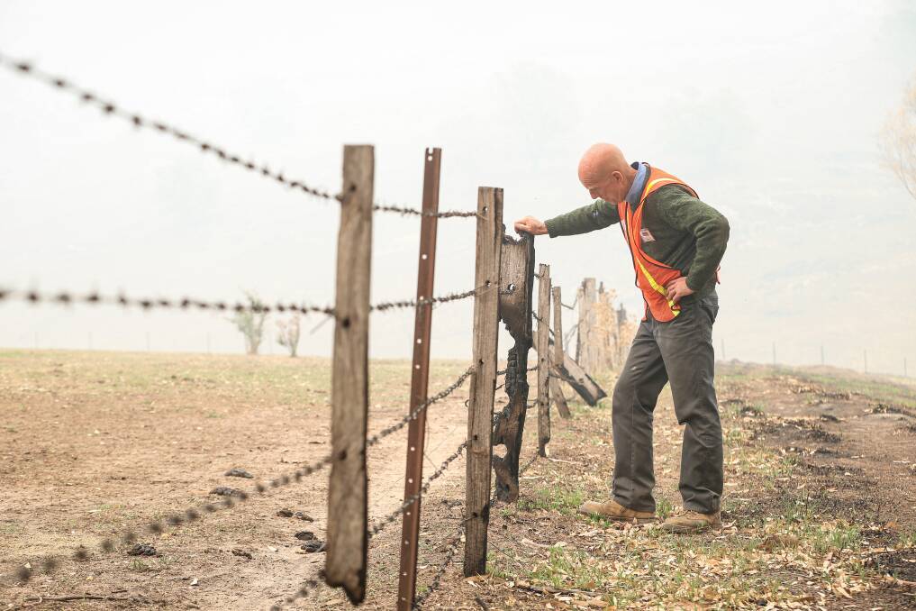 SUPPORT: Blaze Aid volunteer Eugene O'Brien inspects a burnt out fence in Jingellic in February. Coronavirus has hampered recovery efforts in the Upper Murray but Blaze Aid is returning to the region. 