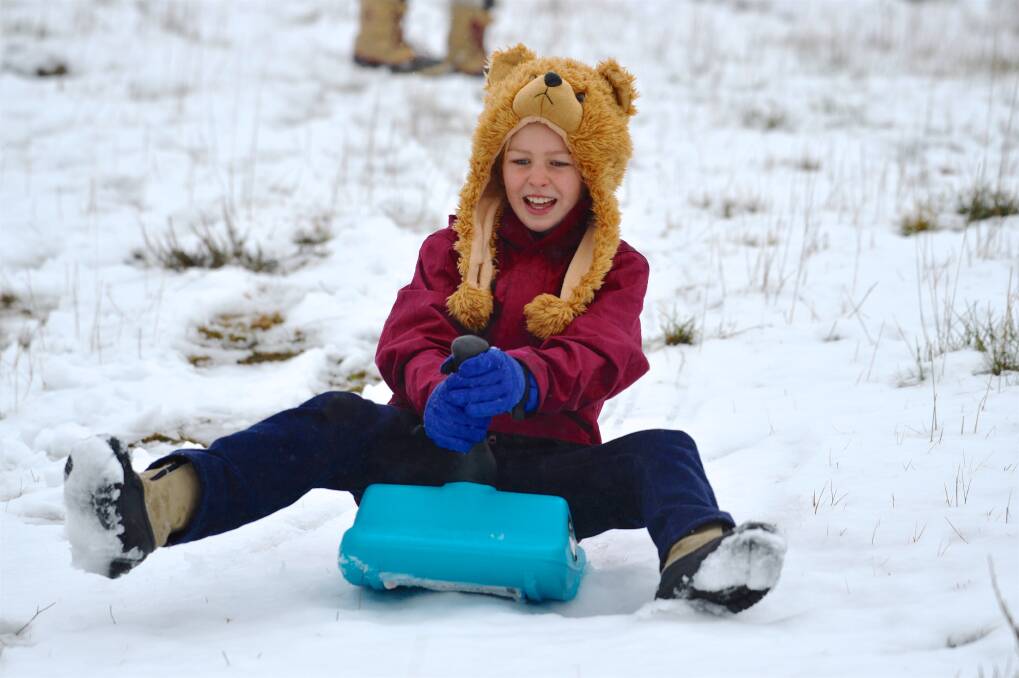 SLOPE: Amelie Thompson 9, takes to the snow on her toboggan in 2016 at Falls Creek. Falls Creek and Mt Hotham will continue to allow tobogganing despite bans at Perisher and Thredbo.