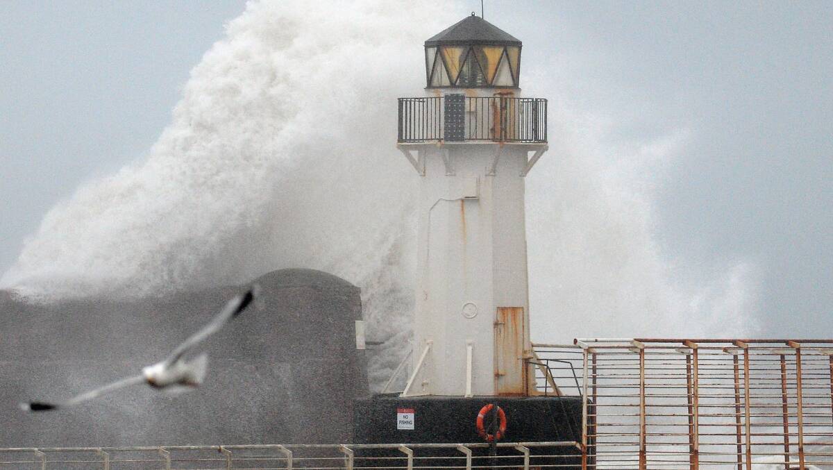 Waves crash over Ardrossan harbour lighthouse on January 3, 2014 in Ardrossan, Scotland. Picture: Getty