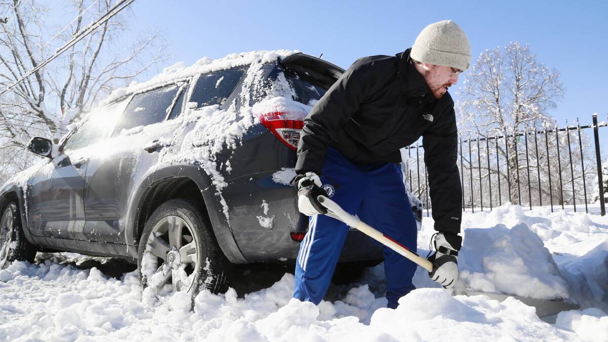Dan Devine shovels snow away so he can get his vehicle out near his home in Indianapolis, Indiana, January 7, 2014. Photo: REUTERS/Brent Smith