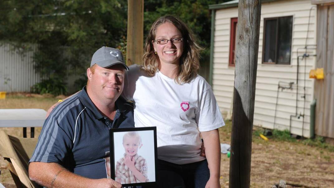 Jon and Michelle Seccull hold a picture of their son Ethan. The couple are urging families to talk to their loved ones about organ donation and consider joining the Australian Organ Donor Register. Picture: Kate Healy